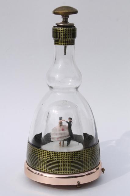 60s vintage decanter bottle, dancing couple music box plays waltz On the Street Where You Live