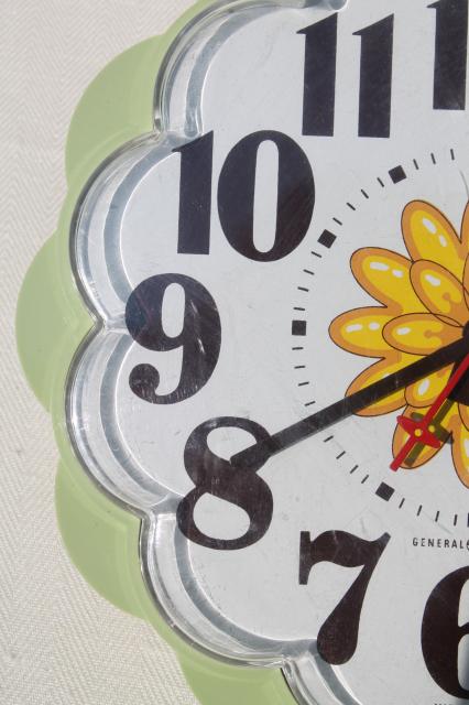 70s vintage GE electric wall clock, retro avocado green plastic daisy kitchen clock