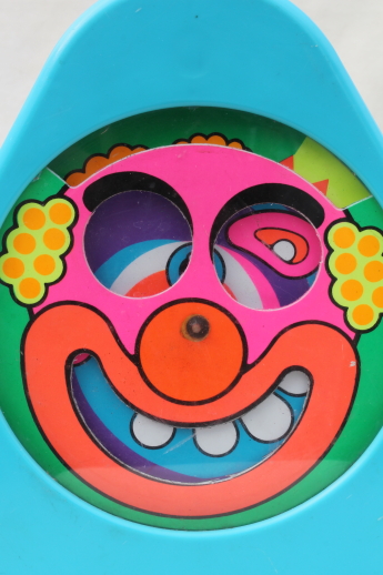 70s vintage Mattel baby toy, spinning face clown psychedelic color spirals