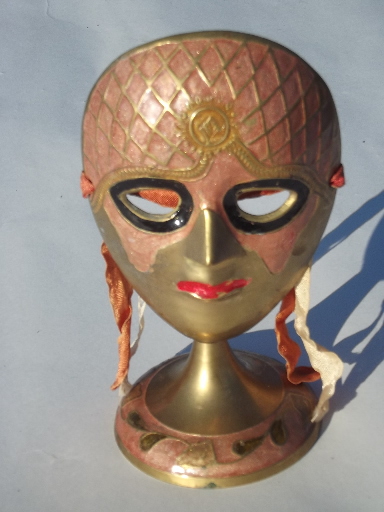 Enameled brass mask on display stand, masked face made in India