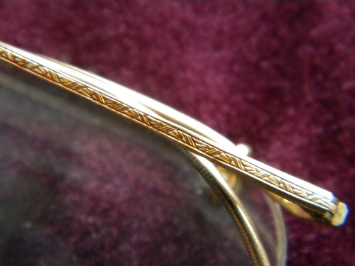 Old gold rimless spectacles or eyeglass frames, vintage Bausch & Lomb