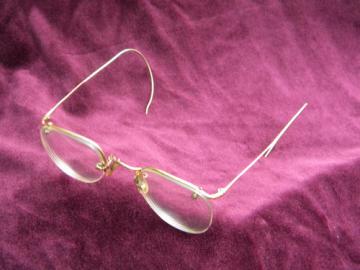 Old gold rimless spectacles or eyeglass frames, vintage Bausch & Lomb