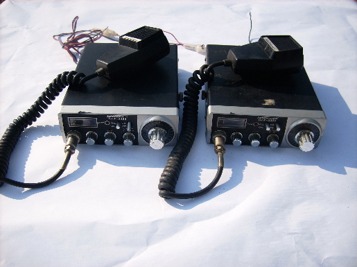 Pair of vintage Gemtronics GTX 3323 mobile CB transceiver radios with microphones and manual