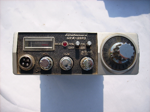 Pair of vintage Gemtronics GTX 3323 mobile CB transceiver radios with microphones and manual