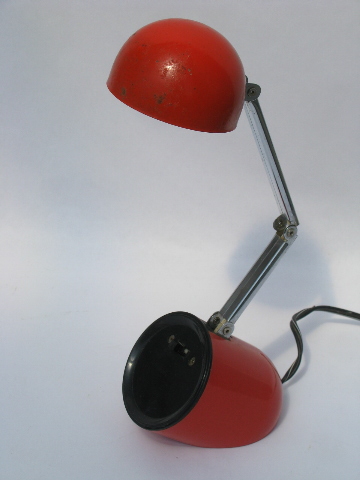 Retro mod red-orange bullet shape reading or desk light, folds to capsule