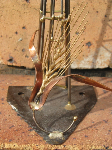 Hand-crafted metal art copper windmill built on old farm mower tooth