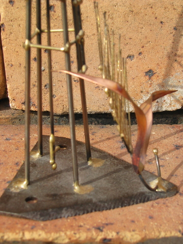 Hand-crafted metal art copper windmill built on old farm mower tooth