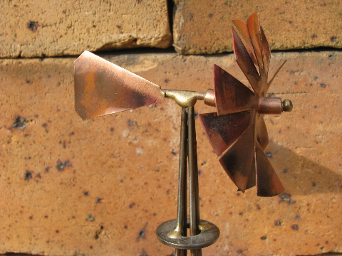 Hand-crafted metal art copper windmill built on old farm mower tooth