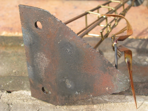 Hand-crafted metal art copper windmill built on old farm mower tooth