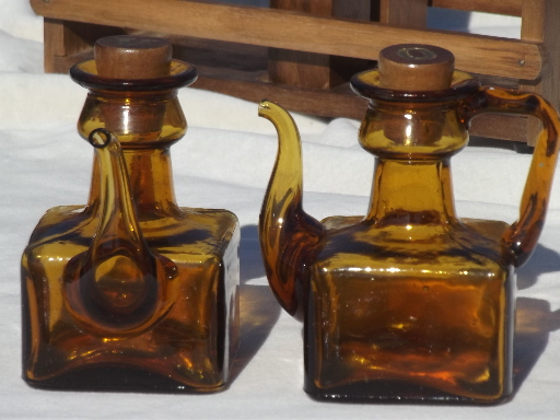 Vintage amber glass hand-blown cruet bottles in rustic wood table set