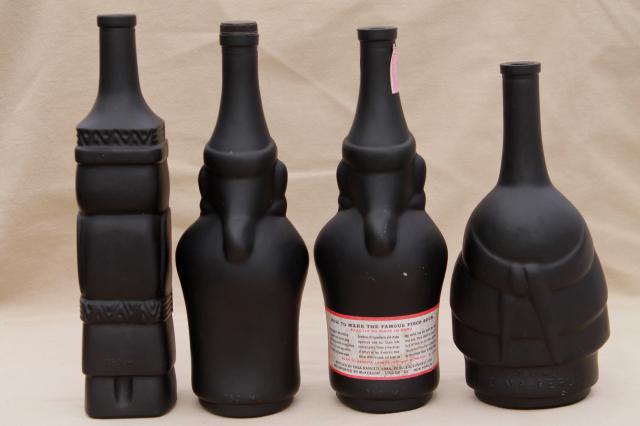 vintage black glass Inca Pisco bottles, tiki style indian heads & totem