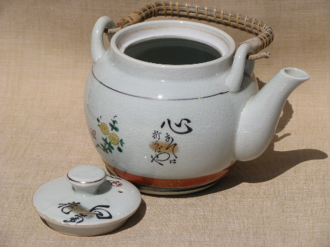Wicker handle pottery teapot and bowl cups, vintage Japan painted tea set